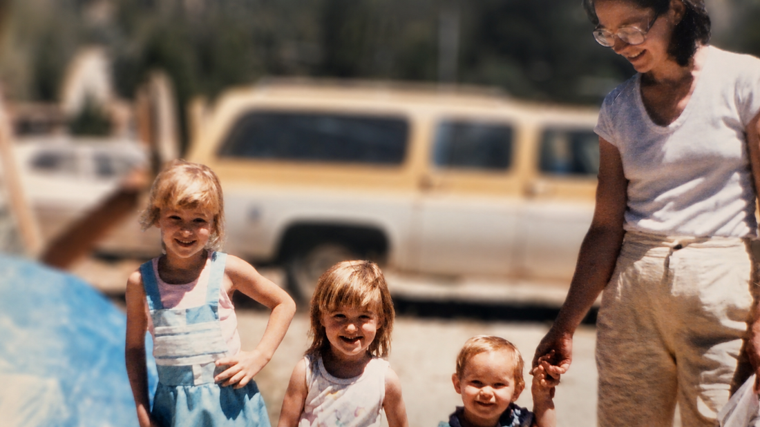 Vintage family photo of a mother holding a child’s hand with smiling children, evoking heartfelt Mother’s Day card messages and family memories.