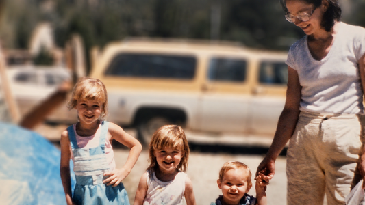 Vintage family photo of a mother holding a child’s hand with smiling children, evoking heartfelt Mother’s Day card messages and family memories.