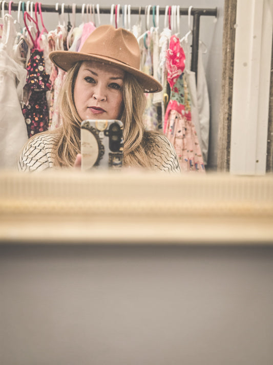 Self-portrait of the Vintage Hearts Club founder wearing a classic vintage hat, capturing timeless charm and old-soul elegance.