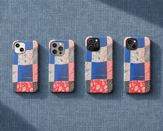 iphone 14 cases with a colorful patchwork design are lined up on a textured blue fabric background.